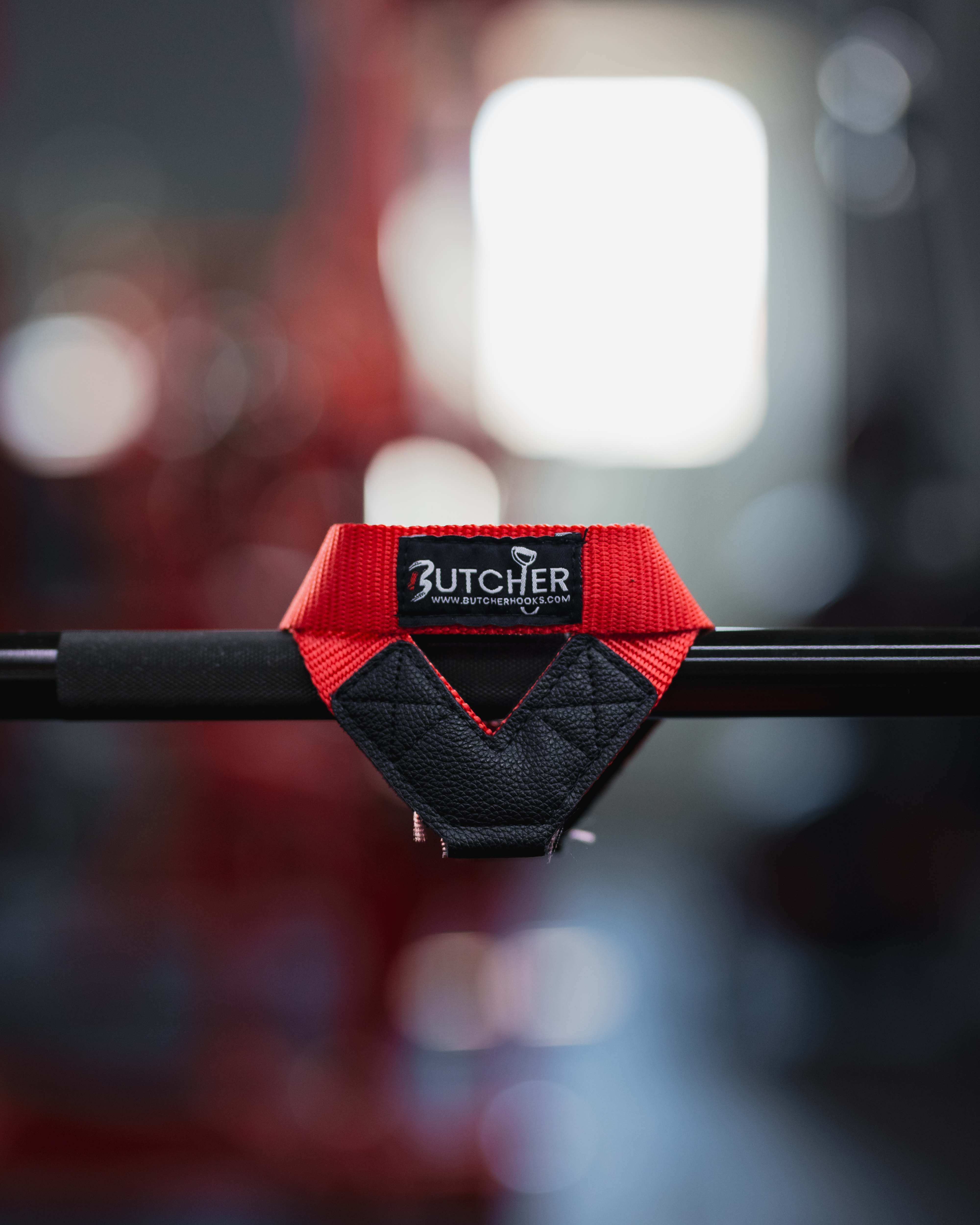 Red Butcher lifting hooks wrapped over a barbell